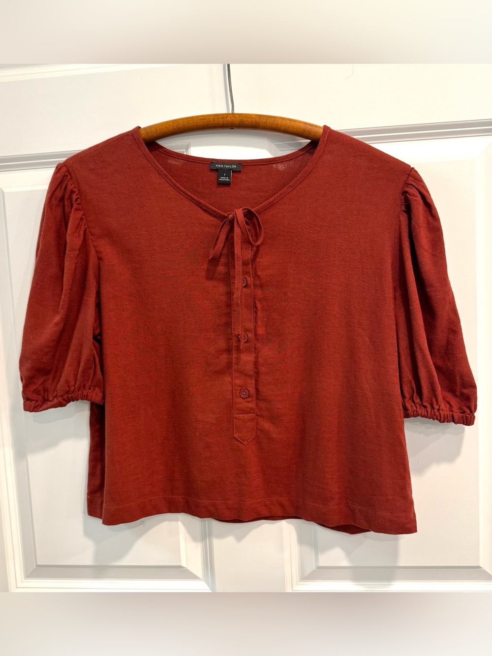 Ann Taylor red puff-sleeve top with a tie-neck and button-down front.